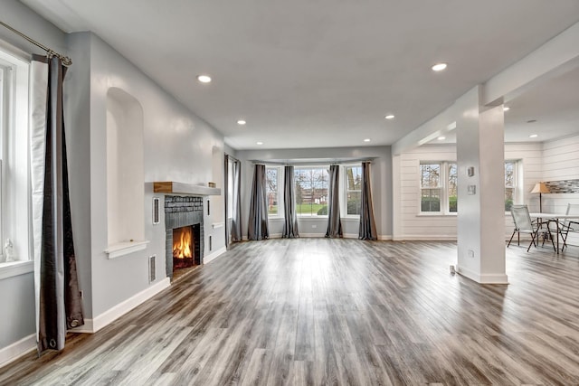2425 Flossmoor Rd, Flossmoor, IL 60422 - unfurnished living room with wood finished floors, a warm lit fireplace, recessed lighting, and arched walkways