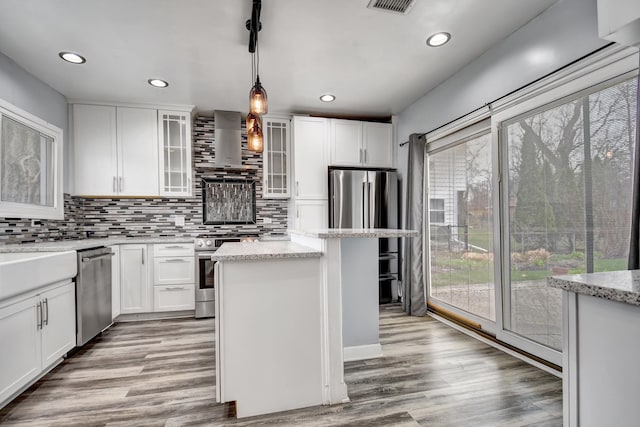 2425 Flossmoor Rd, Flossmoor, IL 60422 - kitchen featuring stainless steel appliances, wall chimney exhaust hood, tasteful backsplash, white cabinetry, and recessed lighting