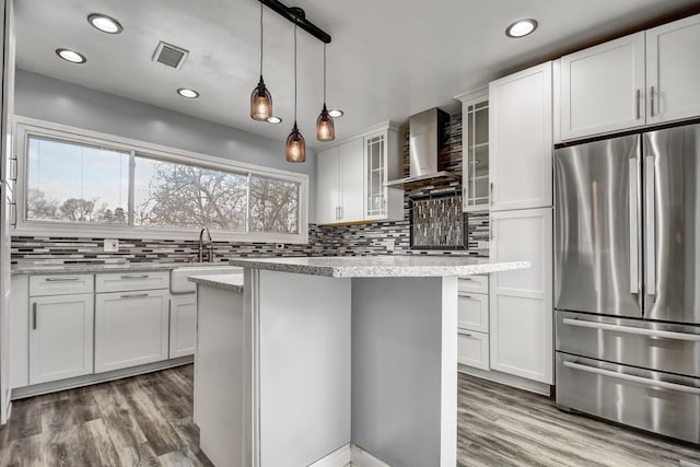 2425 Flossmoor Rd, Flossmoor, IL 60422 - kitchen featuring freestanding refrigerator, wall chimney range hood, light wood-style floors, decorative backsplash, and recessed lighting