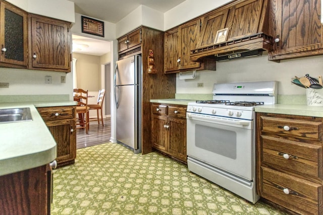 3536 Buck Ave, Joliet, IL 60431 - kitchen featuring gas range gas stove, freestanding refrigerator, ventilation hood, light countertops, and light floors