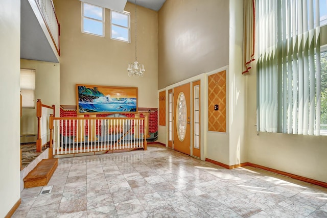 6238 S Kolmar Ave, Chicago, IL 60629 - foyer entrance with a chandelier, a high ceiling, a baseboard heating unit, and marble finish floors