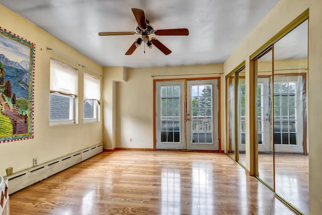 6238 S Kolmar Ave, Chicago, IL 60629 - unfurnished room with a baseboard radiator, ceiling fan, french doors, and wood finished floors