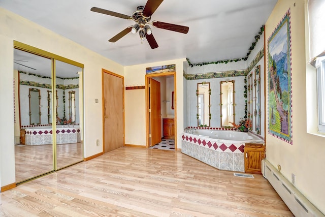 6238 S Kolmar Ave, Chicago, IL 60629 - unfurnished bedroom with a baseboard heating unit, wood finished floors, two closets, and ensuite bath
