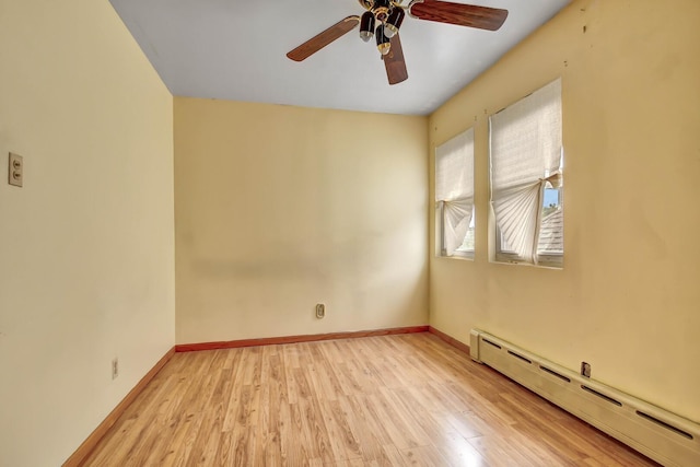 6238 S Kolmar Ave, Chicago, IL 60629 - spare room featuring a baseboard heating unit, light wood-type flooring, and ceiling fan