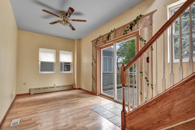 6238 S Kolmar Ave, Chicago, IL 60629 - doorway to outside featuring a baseboard radiator, wood finished floors, a ceiling fan, and stairway