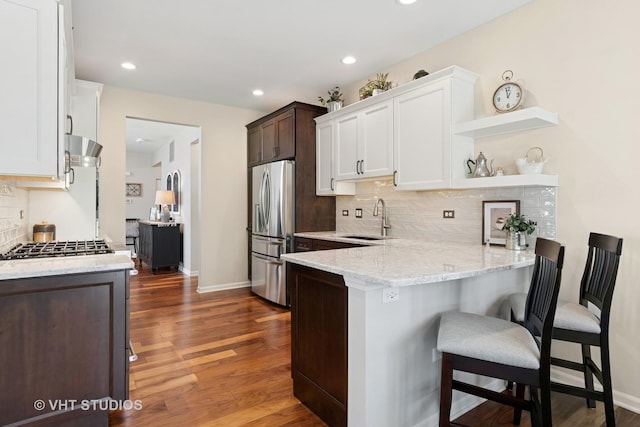 4015 Chesapeake Ln, Naperville, IL 60564 - kitchen with stainless steel appliances, a peninsula, light stone counters, backsplash, and open shelves
