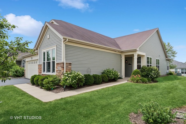4015 Chesapeake Ln, Naperville, IL 60564 - view of front of house featuring a front yard, a garage, stone siding, a shingled roof, and driveway