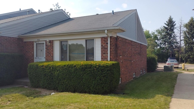 400 Salem Sq Unit 000, Bolingbrook, IL 60440 - view of home's exterior with brick siding, a lawn, and a shingled roof