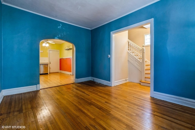2721 W Prindiville St, Chicago, IL 60647 - empty room with ornamental molding, stairway, hardwood / wood-style floors, and arched walkways