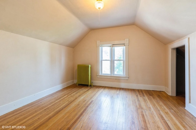 2721 W Prindiville St, Chicago, IL 60647 - additional living space featuring radiator, light wood finished floors, and lofted ceiling