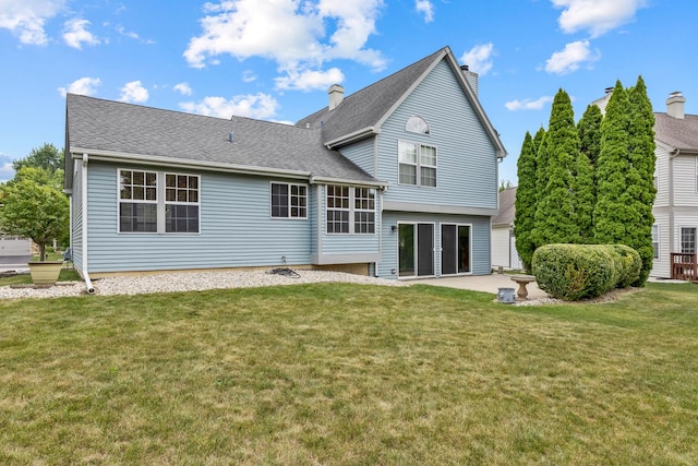 395 Wildberry Ln, Bartlett, IL 60103 - back of property with a chimney, a lawn, a patio area, and roof with shingles