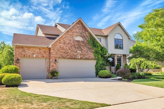 531 Danbury Dr, Oswego, IL 60543 - traditional home with driveway, brick siding, an attached garage, and roof with shingles