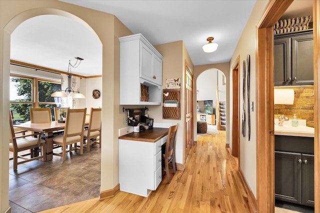 531 Danbury Dr, Oswego, IL 60543 - kitchen featuring arched walkways, tasteful backsplash, light wood-type flooring, and open shelves