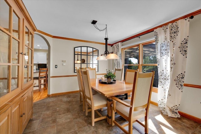 531 Danbury Dr, Oswego, IL 60543 - dining room with healthy amount of natural light, ornamental molding, and arched walkways