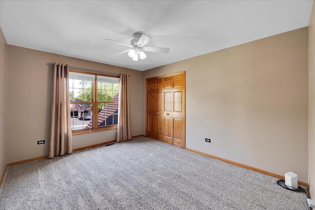531 Danbury Dr, Oswego, IL 60543 - unfurnished bedroom with light carpet, a ceiling fan, and a closet