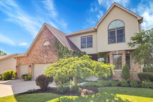 531 Danbury Dr, Oswego, IL 60543 - view of front of house with brick siding, concrete driveway, an attached garage, and a front yard