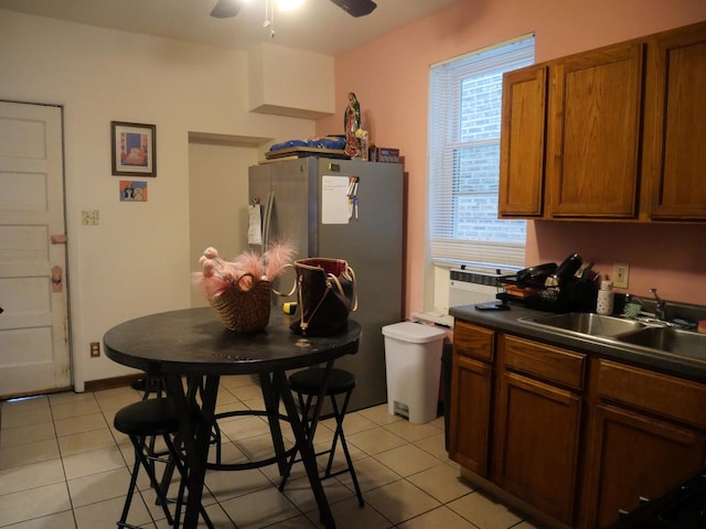 4417 S Campbell Ave, Chicago, IL 60632 - kitchen featuring dark countertops, a ceiling fan, brown cabinets, light tile patterned flooring, and freestanding refrigerator