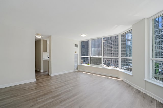 405 N Wabash Ave Unit 506, Chicago, IL 60611 - spare room featuring wood finished floors and baseboards