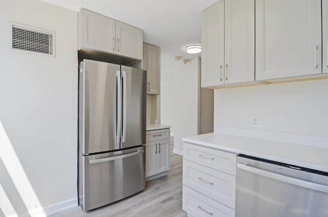 405 N Wabash Ave Unit 506, Chicago, IL 60611 - kitchen with appliances with stainless steel finishes, light wood-style floors, and light countertops
