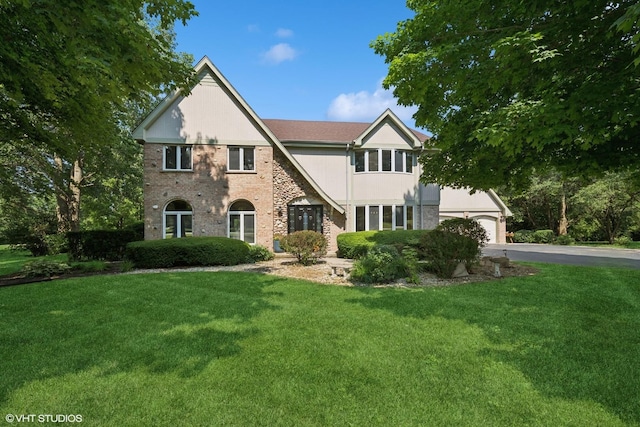 6579 Windham Ln, Long Grove, IL 60047 - tudor home featuring asphalt driveway, a front lawn, and an attached garage
