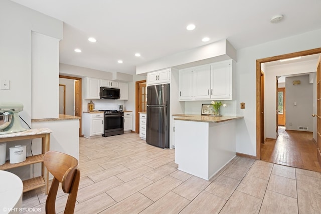 6579 Windham Ln, Long Grove, IL 60047 - kitchen featuring freestanding refrigerator, electric stove, black microwave, a peninsula, and white cabinets