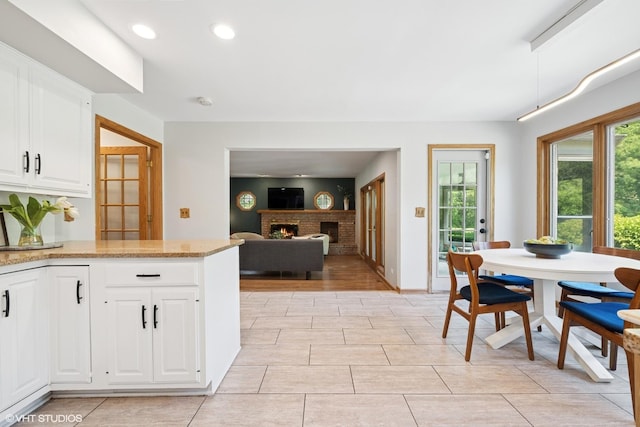 6579 Windham Ln, Long Grove, IL 60047 - kitchen with plenty of natural light, recessed lighting, light stone counters, a fireplace, and white cabinets