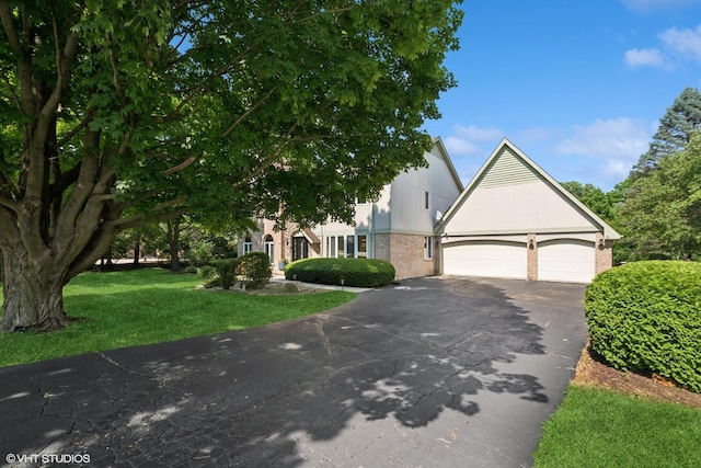 6579 Windham Ln, Long Grove, IL 60047 - obstructed view of property with driveway, a front yard, and an attached garage