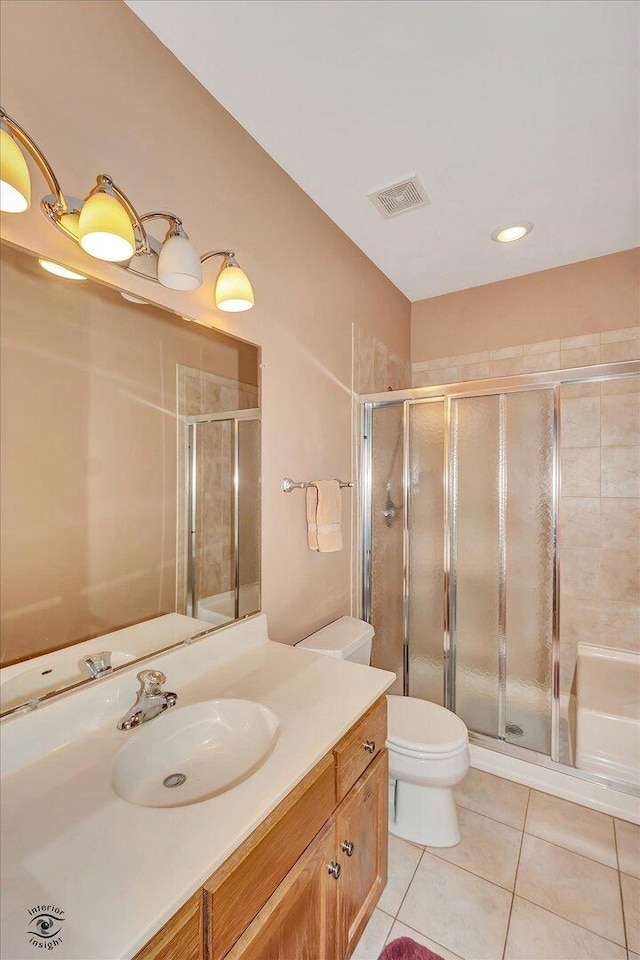 10754 Canterbury Dr, Mokena, IL 60448 - bathroom featuring tile patterned floors, vanity, a stall shower, and recessed lighting