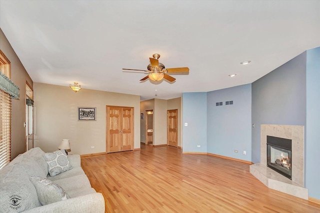 10754 Canterbury Dr, Mokena, IL 60448 - living area featuring light wood-style flooring, a ceiling fan, and a premium fireplace