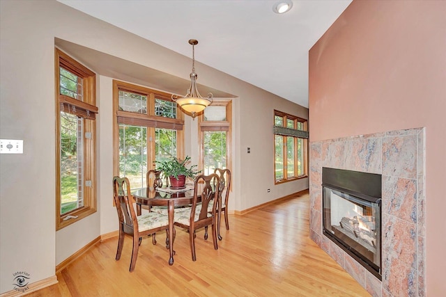 10754 Canterbury Dr, Mokena, IL 60448 - dining room with healthy amount of natural light, light wood-style floors, and a tile fireplace