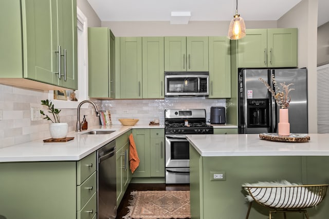823 N Marshfield Ave Unit 2, Chicago, IL 60622 - kitchen with stainless steel appliances, green cabinets, light countertops, and a kitchen breakfast bar