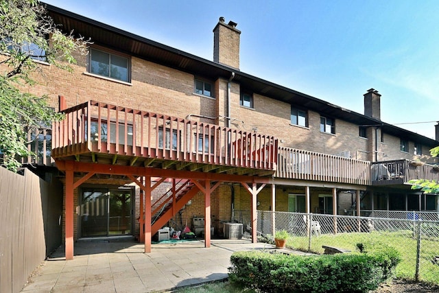 300 Duane St Unit 6, Glen Ellyn, IL 60137 - back of property with brick siding, a chimney, a deck, and a patio area