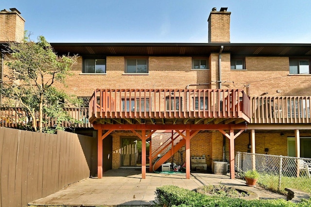 300 Duane St Unit 6, Glen Ellyn, IL 60137 - rear view of property featuring brick siding, a chimney, a deck, and a patio