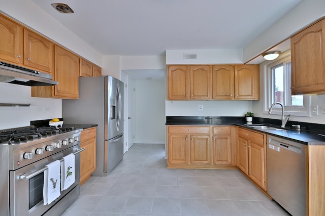 300 Duane St Unit 6, Glen Ellyn, IL 60137 - kitchen featuring stainless steel appliances, under cabinet range hood, light tile patterned floors, and dark countertops