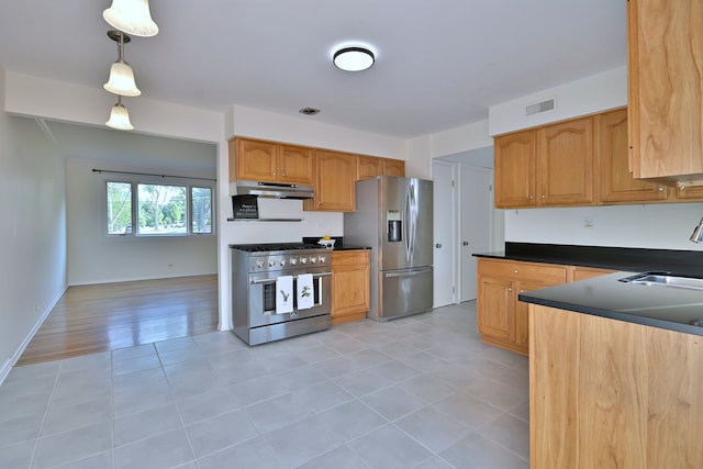 300 Duane St Unit 6, Glen Ellyn, IL 60137 - kitchen with appliances with stainless steel finishes, under cabinet range hood, dark countertops, and light tile patterned floors