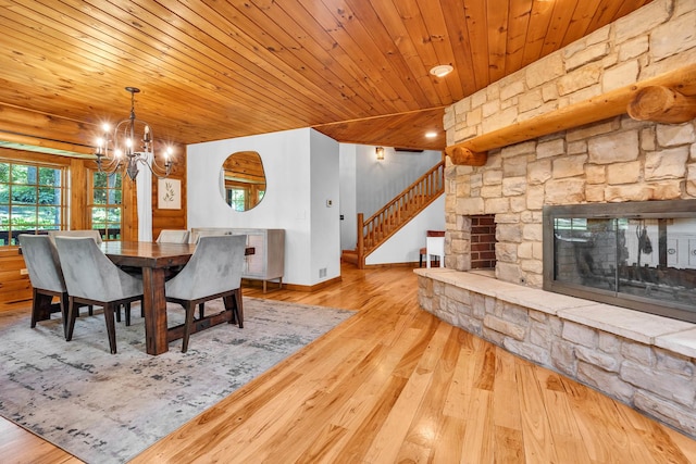 3903 Niblick Ct, Crystal Lake, IL 60012 - dining space featuring a chandelier, hardwood / wood-style floors, wooden ceiling, stairs, and a fireplace