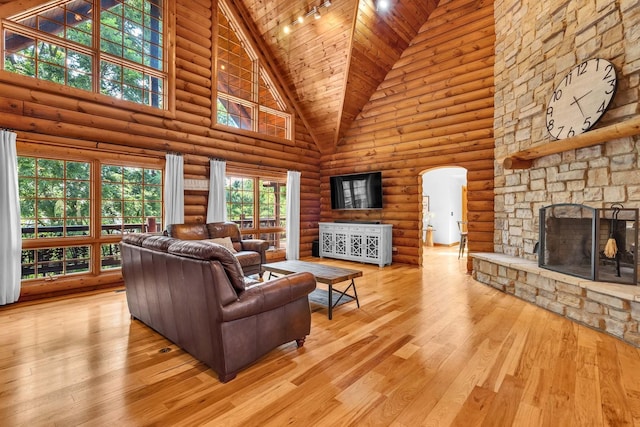 3903 Niblick Ct, Crystal Lake, IL 60012 - living room featuring high vaulted ceiling, arched walkways, a fireplace, wood-type flooring, and log walls