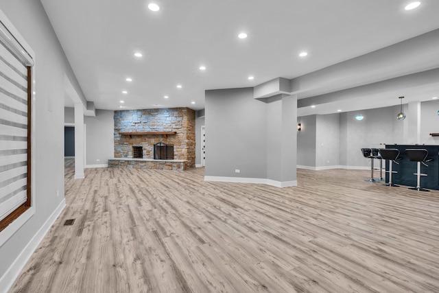 3903 Niblick Ct, Crystal Lake, IL 60012 - unfurnished living room featuring wood finished floors, recessed lighting, bar area, and a stone fireplace