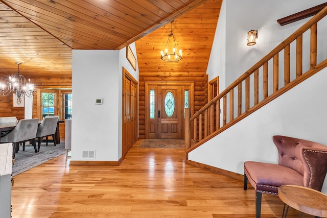 3903 Niblick Ct, Crystal Lake, IL 60012 - foyer featuring a chandelier, stairway, log walls, wooden ceiling, and light wood-style flooring