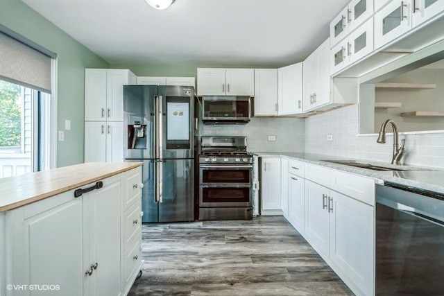 18550 W Sterling Ct W Unit 18550, Grayslake, IL 60030 - kitchen with stainless steel appliances, light countertops, white cabinetry, glass insert cabinets, and tasteful backsplash