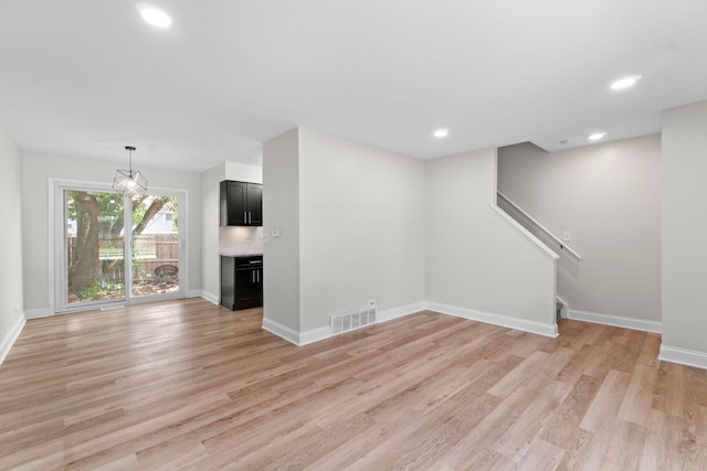 1022 Ashton Ct, Streamwood, IL 60107 - unfurnished living room featuring light wood-style flooring, stairway, and recessed lighting