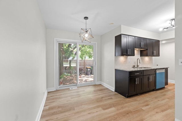 1022 Ashton Ct, Streamwood, IL 60107 - kitchen with a chandelier, dishwashing machine, light wood-style floors, tasteful backsplash, and light stone counters