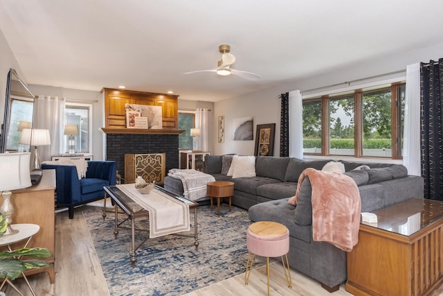 16064 Raintree Rd, Bloomington, IL 61705 - living area featuring a ceiling fan, light wood finished floors, and a brick fireplace
