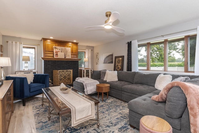 16064 Raintree Rd, Bloomington, IL 61705 - living room featuring light wood-style floors, ceiling fan, a fireplace, and recessed lighting