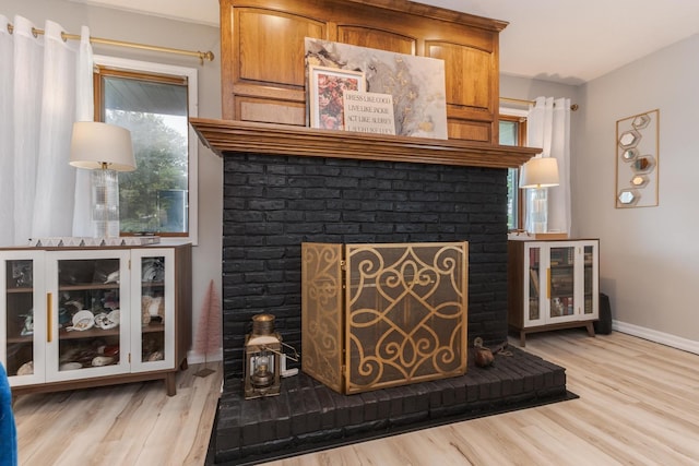 16064 Raintree Rd, Bloomington, IL 61705 - detailed view of a brick fireplace and wood finished floors