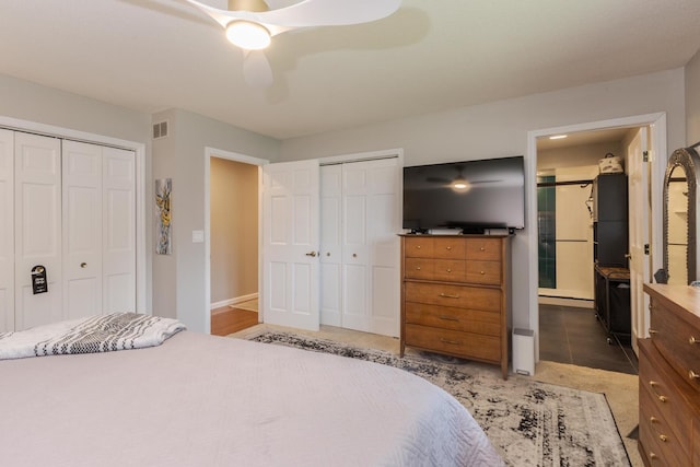 16064 Raintree Rd, Bloomington, IL 61705 - bedroom featuring multiple closets and a ceiling fan
