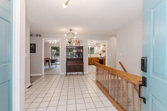 16064 Raintree Rd, Bloomington, IL 61705 - foyer with a chandelier and light tile patterned floors