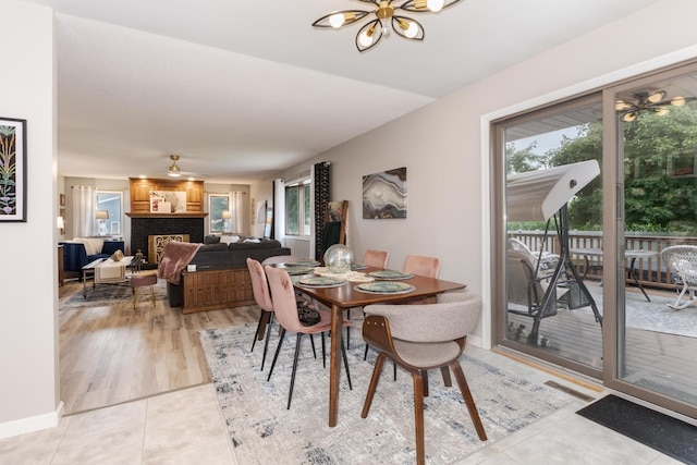 16064 Raintree Rd, Bloomington, IL 61705 - dining space featuring healthy amount of natural light, light tile patterned floors, and a brick fireplace