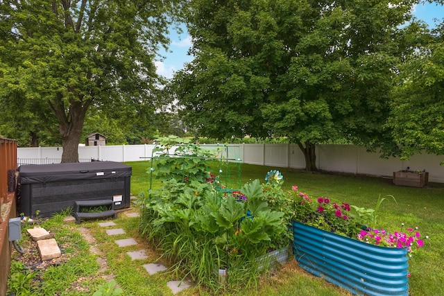 16064 Raintree Rd, Bloomington, IL 61705 - fenced backyard featuring a hot tub and a garden