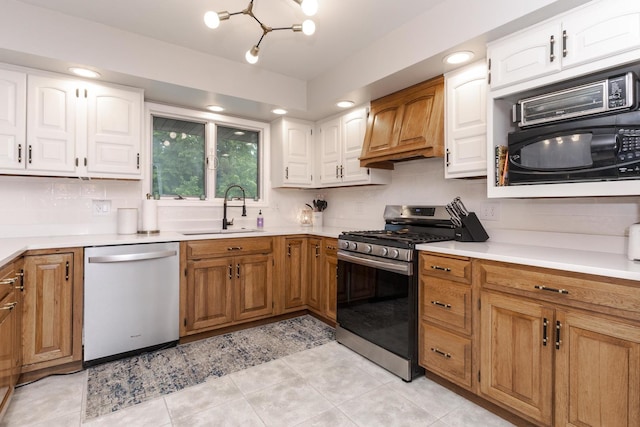 16064 Raintree Rd, Bloomington, IL 61705 - kitchen with stainless steel appliances, premium range hood, light countertops, and white cabinets
